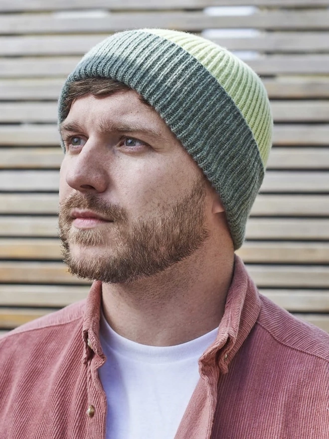 Ribbed Lambswool Unisex Beanie, a person wearing a colourful ribbed beanie outdoors. 