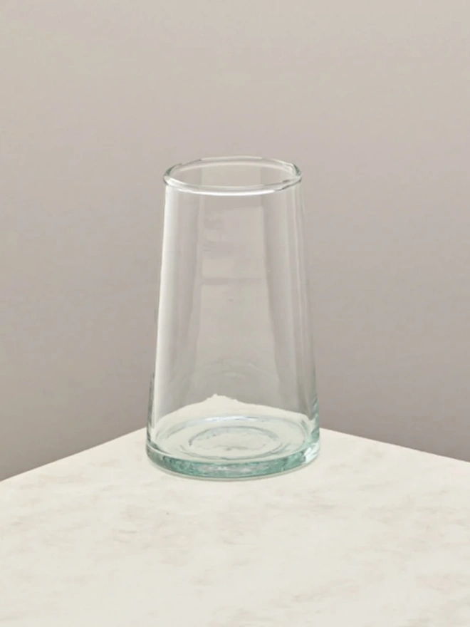Highball Glasses (Set Of 1 Or 4), a highball glass sitting on a plain counter top against a white backdrop. 