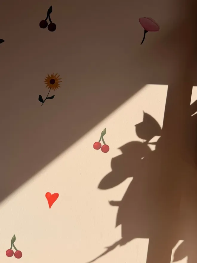 flower stickers on a shadowed wall