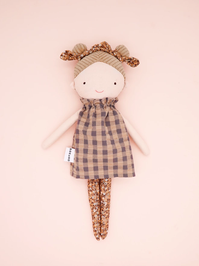 twin bun girl doll with braided blonde hair and gingham dress
