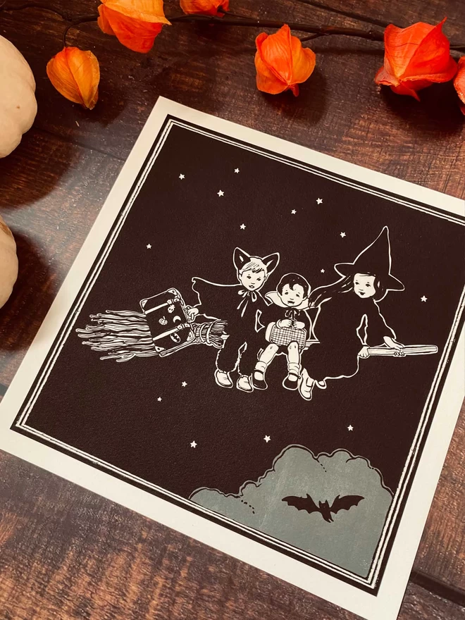 a square digital print of a girl witch and 2 boys drawn in black and white