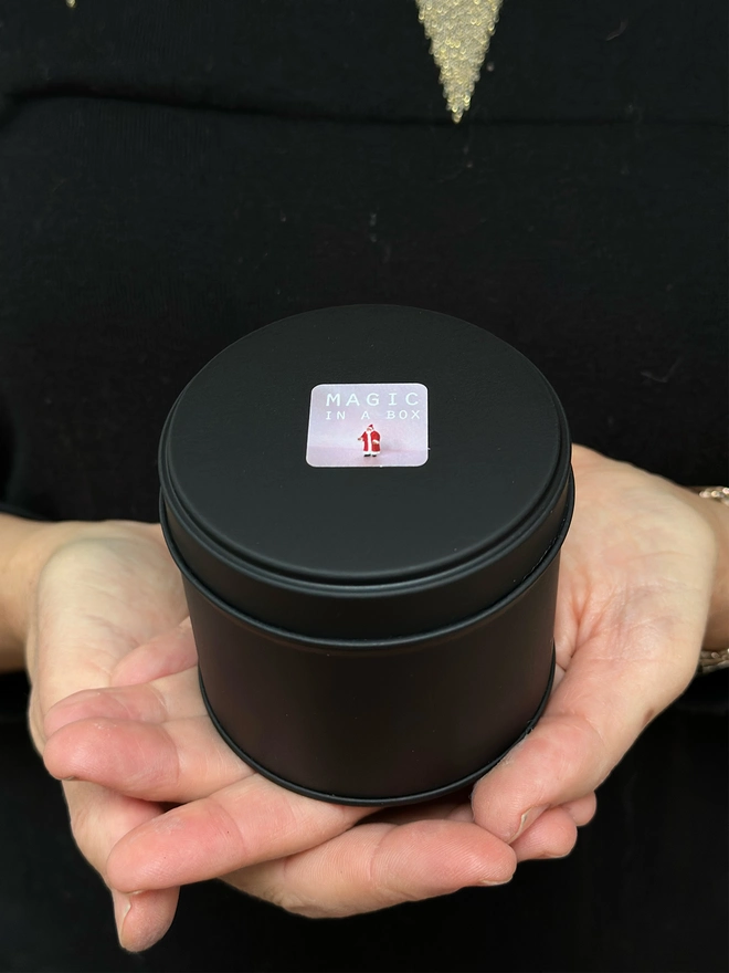 Closed tin containing bauble