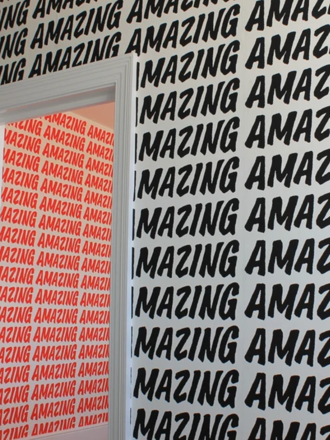 Amazing Wallpaper. An open door surrounded by wallpaper which reads AMAZING in a black, all caps font, repeated. Through the door there is a room with the red variant visible.