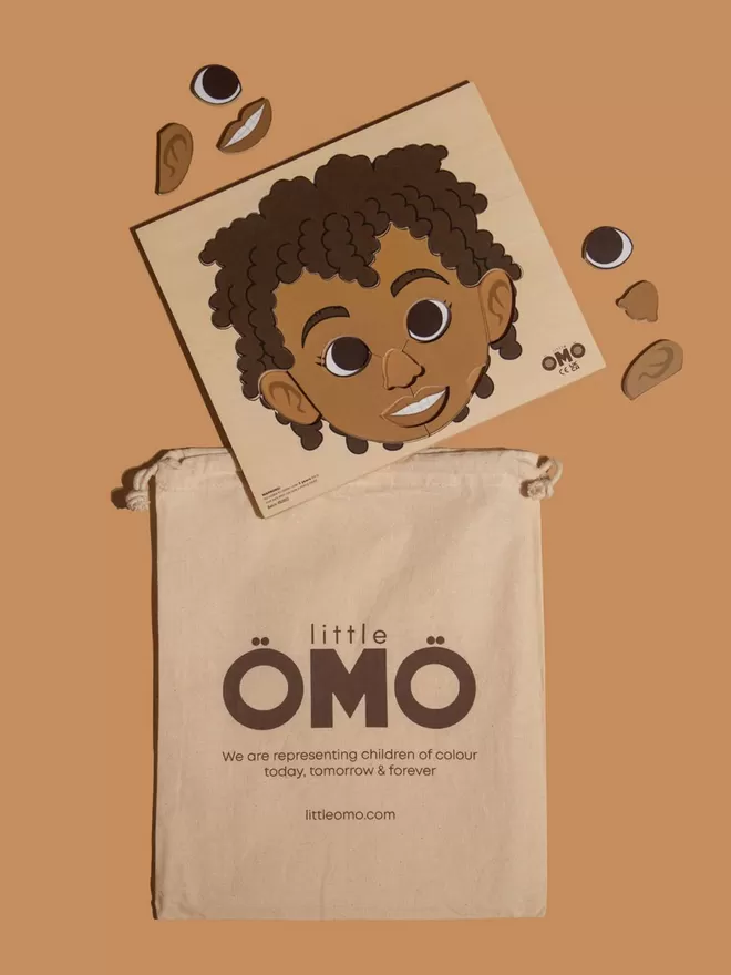 Face Puzzle - Omowale (Boy) with puzzle bag.