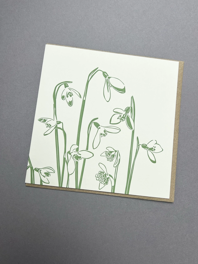 Beautifully detailed green snowdrops on the front if the card