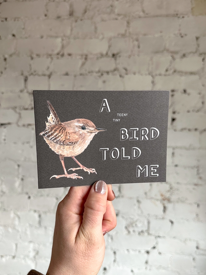 Brown Card Featuring an illustration of a Wren with the text "A teeny tiny bird told me"