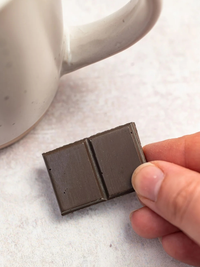 ceramic chocolate magets. a dark chocolate magnet photographed close up.