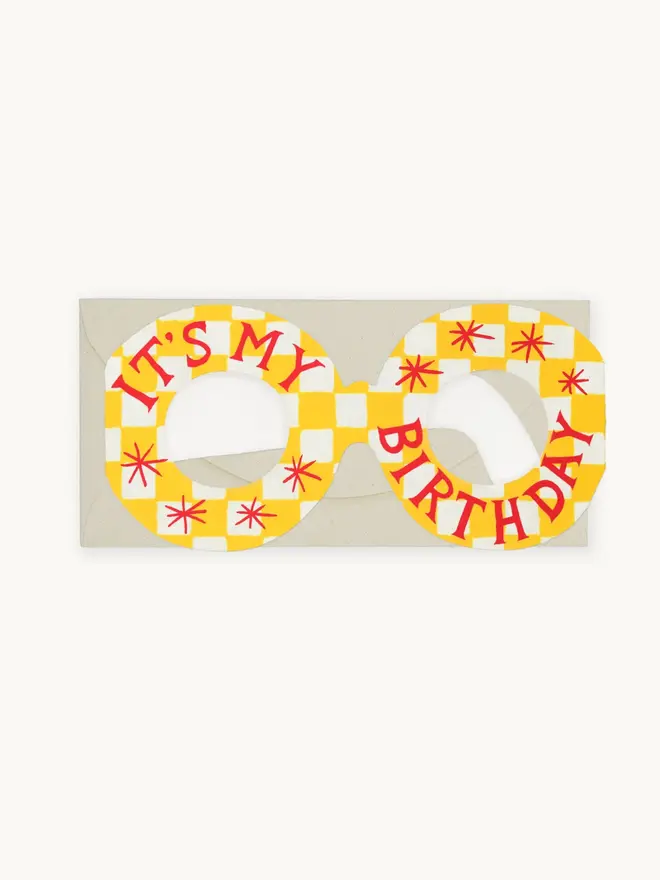 yellow and white grid card in shape of glasses with red birthday text