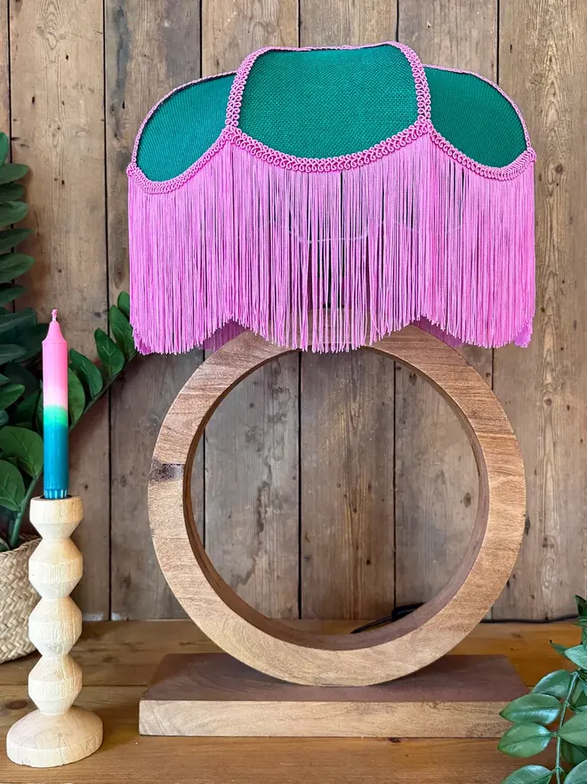 Emerald Green Petal Lampshade With Bubblegum Pink Fringe, in a room. 