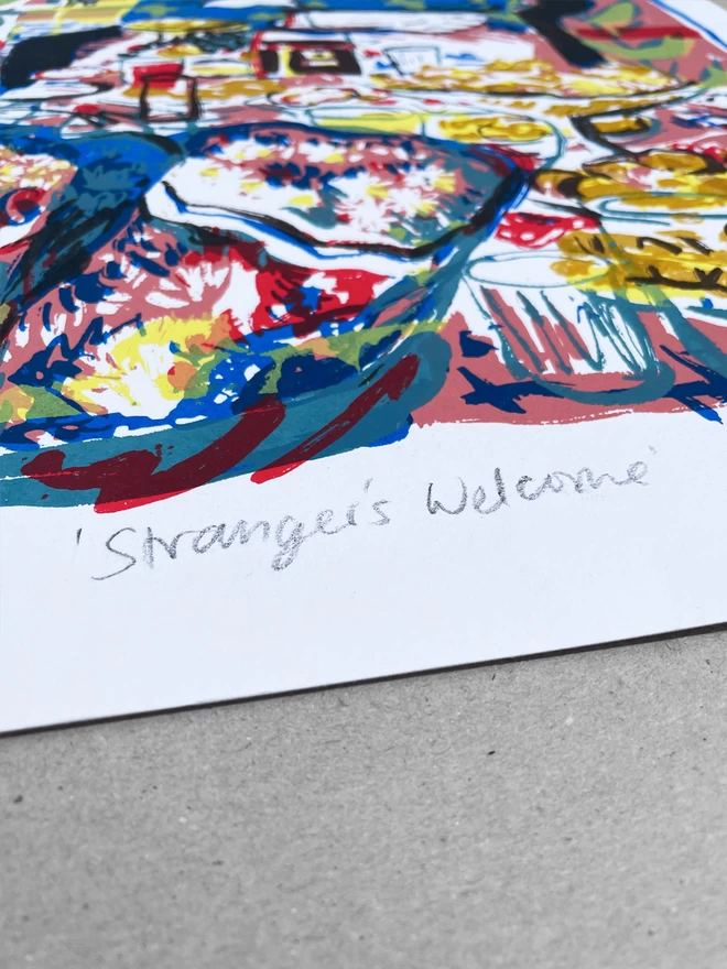 A close up of the title ‘strangers welcome’ written in pencil at the centre, bottom of the print. Laid on a greyboard background 