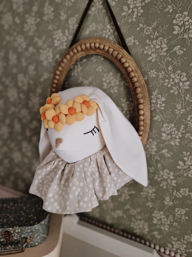 Rabbit Head Wall Mount, a cotton rabbit head wall decoration in a child's bedroom accompanied by other bedroom accessories. 