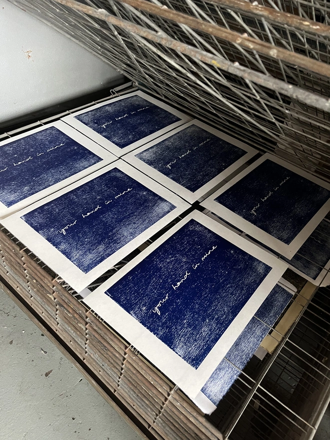 'Your Hand In Mine' Letterpress Print drying on a drying rack
