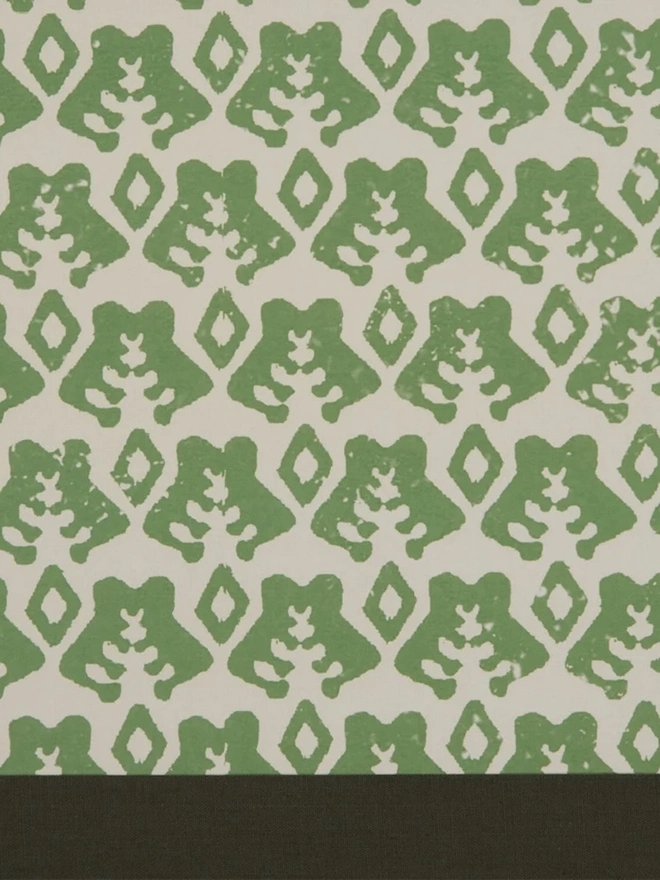 Retro Drum Lampshade. Close-up of a hand block printed lampshade showing a bold repeating geometric pattern. The colourful printed design and neat trim bring character and a handcrafted finish to any lamp.