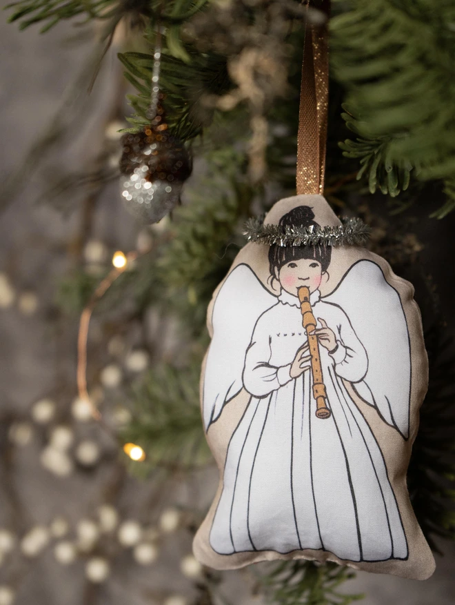 little angel decoartion playing a redorder