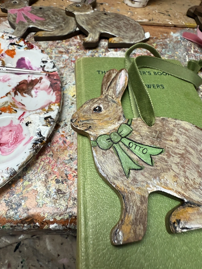 Easter bunny handpainted decoration with green bow and ribbon and the name Otto 