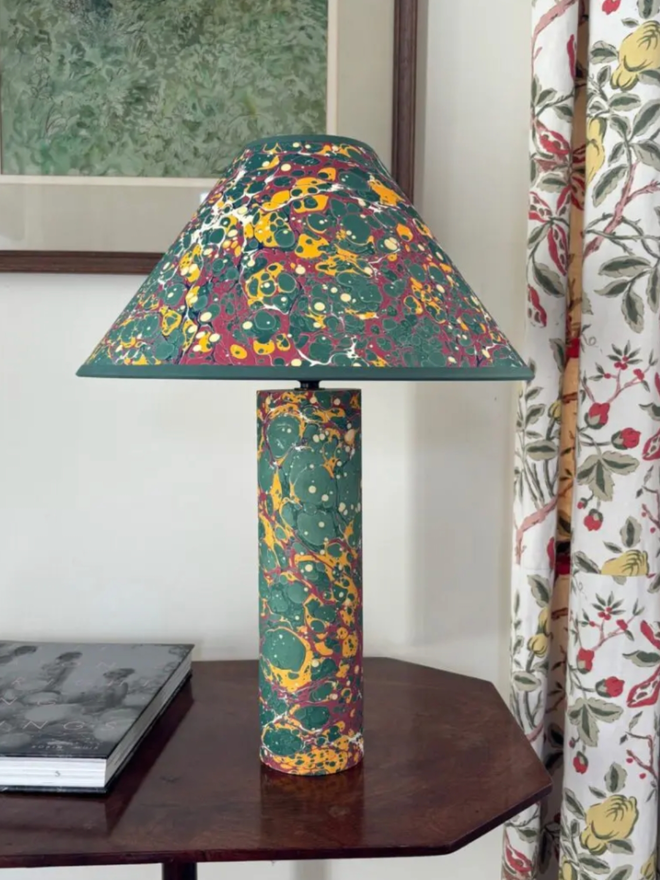 Marbled on Marbled Base & Shade. A dark green and yellow lampshade and base on a table.
