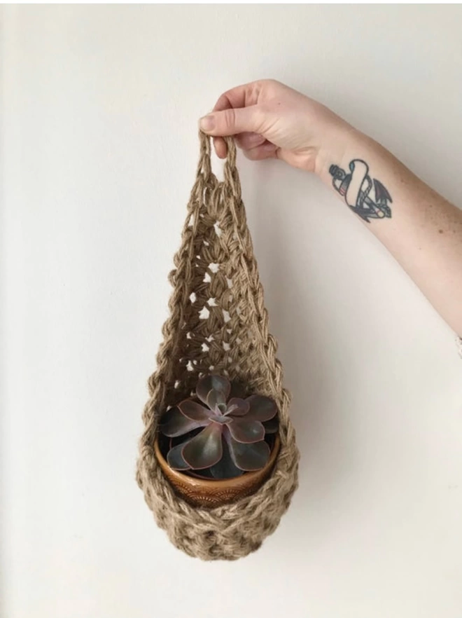 indoor small brown jute hanging wall planter, fabric wall mounted plant holder, handmade crochet plant basket, handmade sustainable crochet decor, rustic natural organic homeware accessories, hanging plant holder 