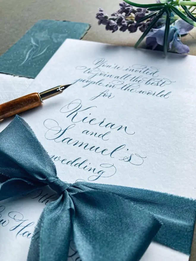bespoke calligraphy wedding invitations. white paper invitations with black calligraphy.