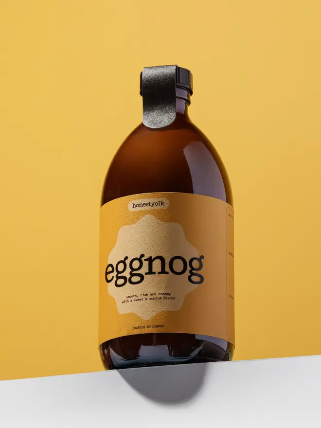 Honest Yolk Hero Image against a yellow background standing on a ledge