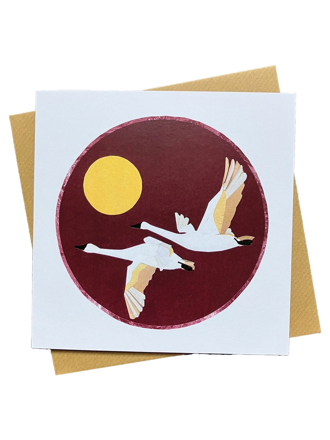 Greetings Card showing a recycled paper collage of two swans flying off into the sunset