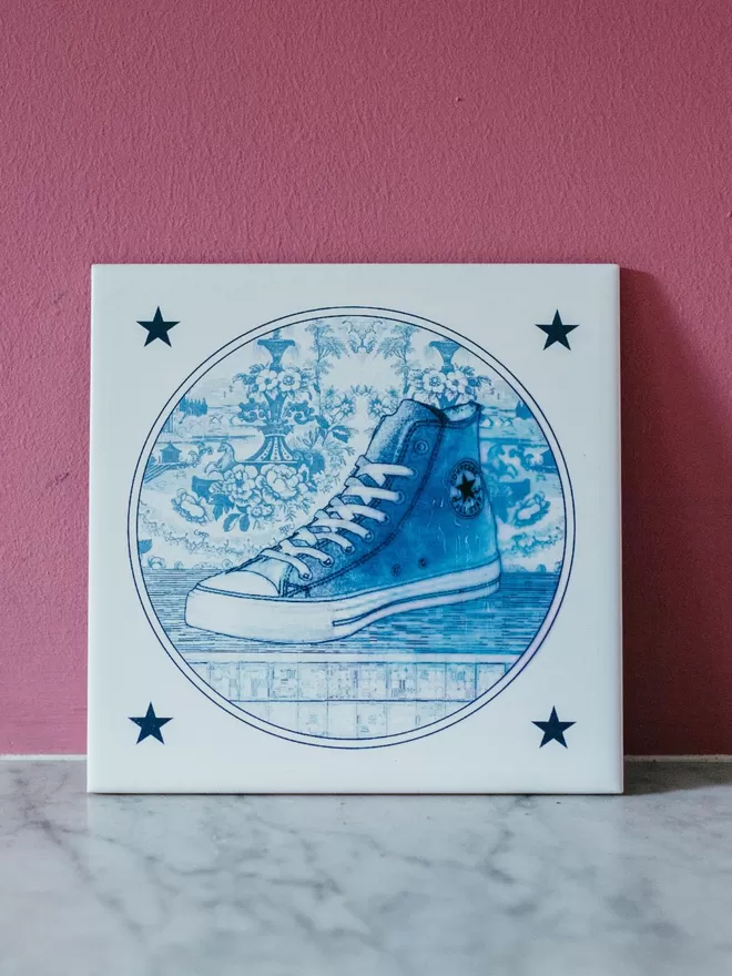 Hand Printed Delft Style Converse All-Stars Tile by Haus of Lucy seen on a mantlepiece.