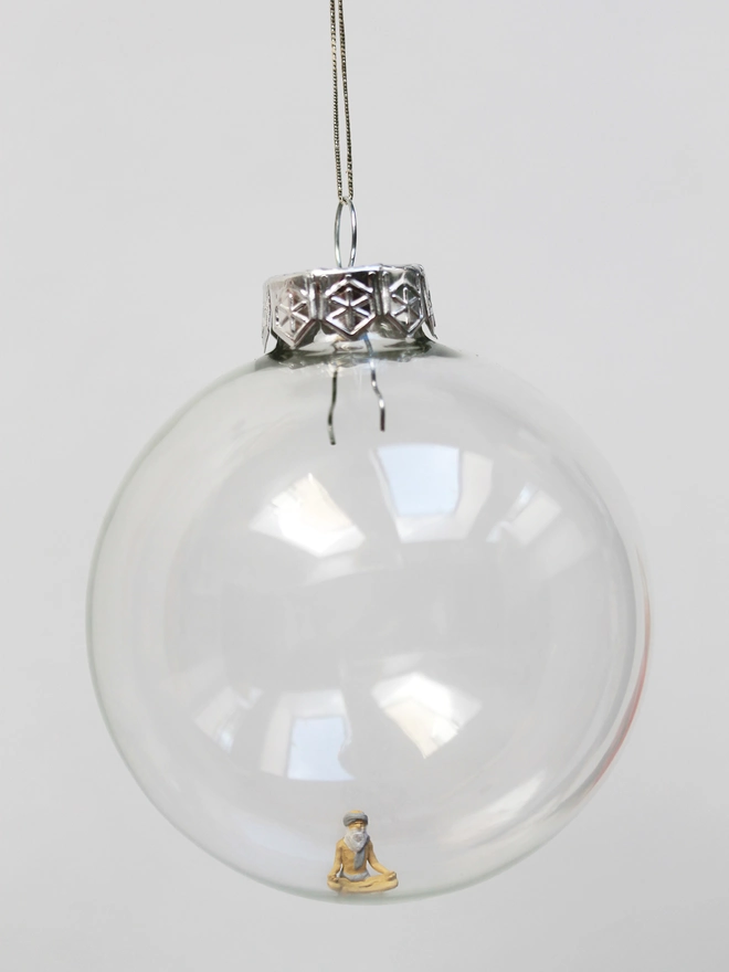 Miniature figure of a Yogi in a glass hanging christmas bauble 