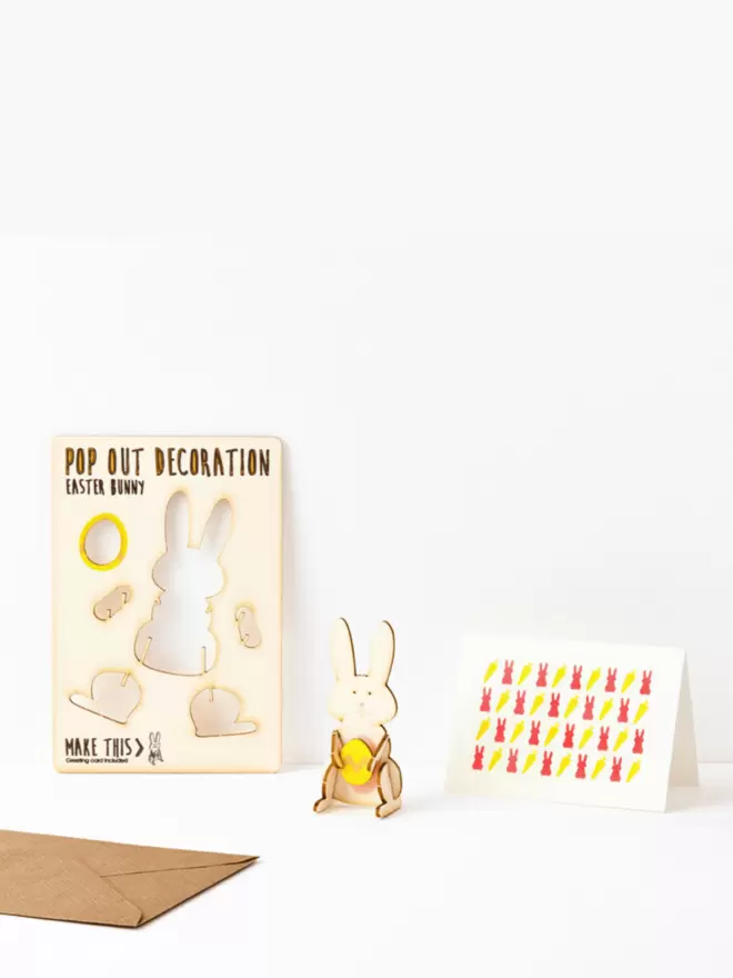 Easter bunny pop out Easter decoration and carrot and rabbit pattern Easter card and brown kraft envelope on a white background