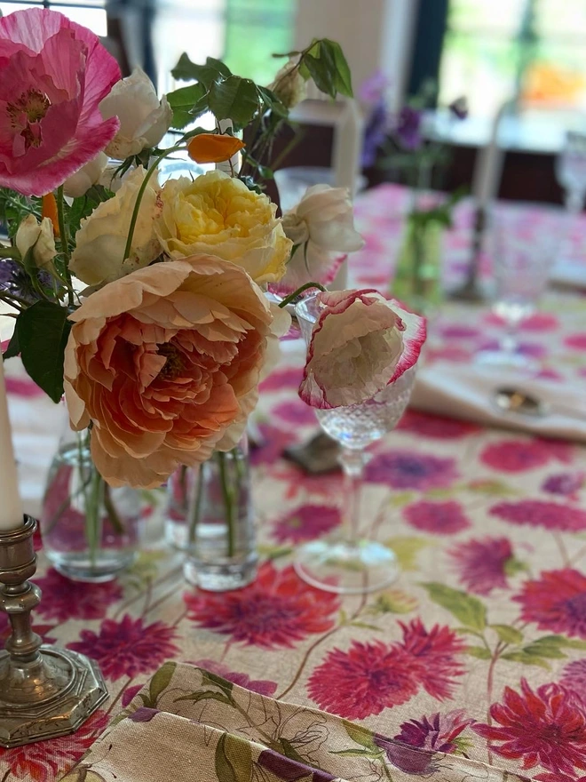 Tablecloth with all over print featuring hand painted dahlia flowers, perfect for summer parties and garden lunches