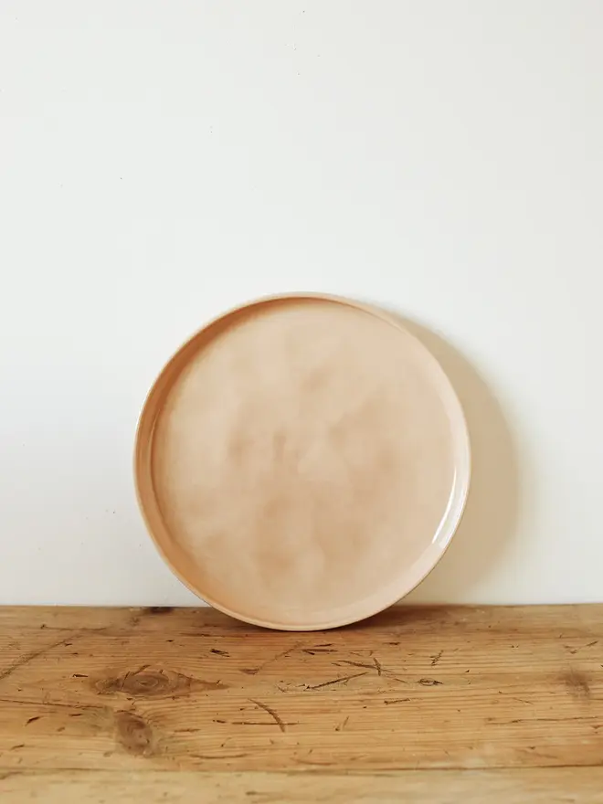 stoneware place setting dining set. a small pink stoneware plate.