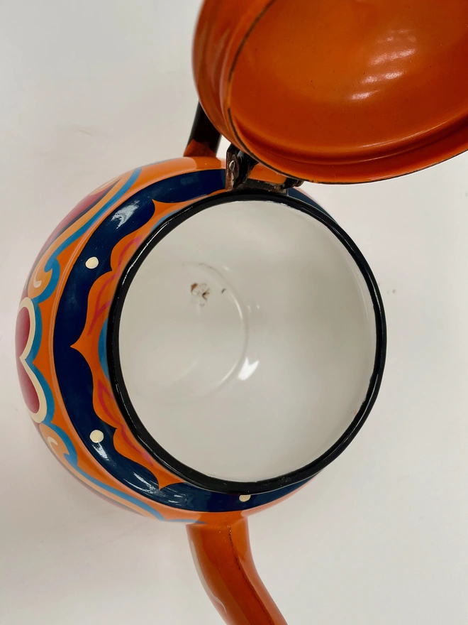 Inside of orange teapot. Enamel is in good condition.