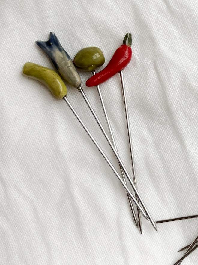 set of 4 cocktail sticks with ceramic toppers in shapes of foods