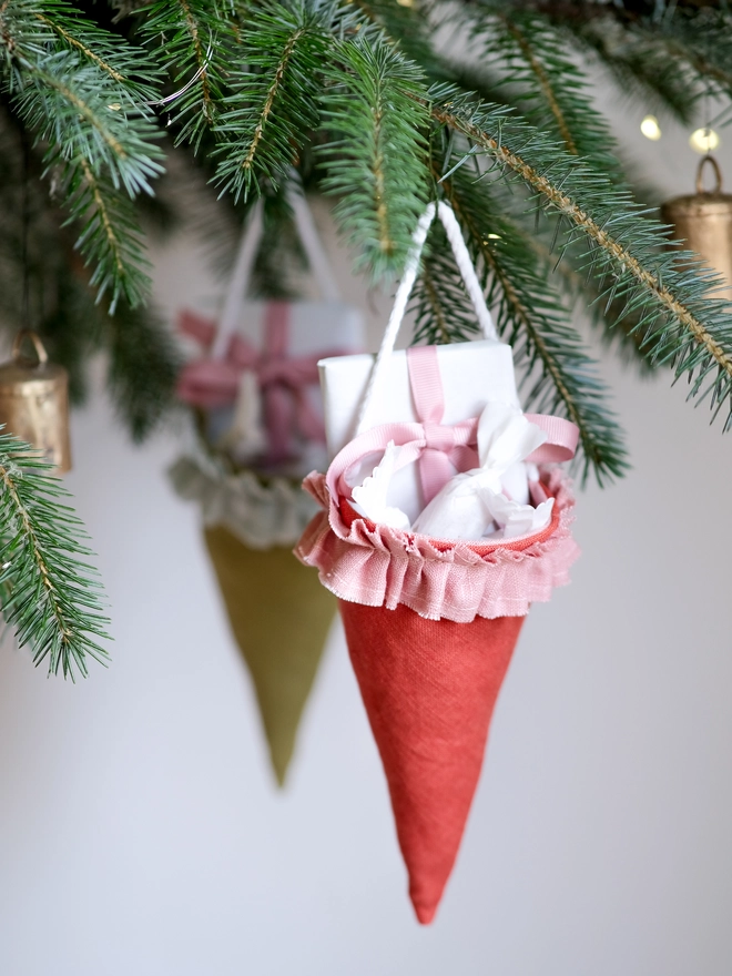 Reusable Victorian Christmas gift cones for hanging beneath festive greenery, featuring delicate ruffled trim.