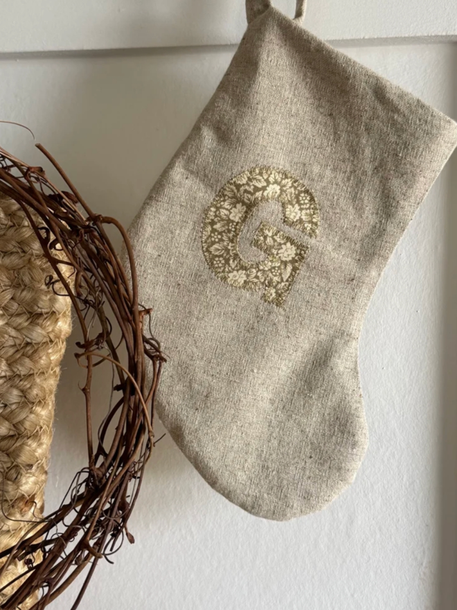 Mini Christmas Stocking with Floral Fabric Initial. A stocking with a floral G initial.