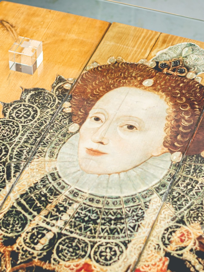 queen elizabeth image on a coffee table with glass top