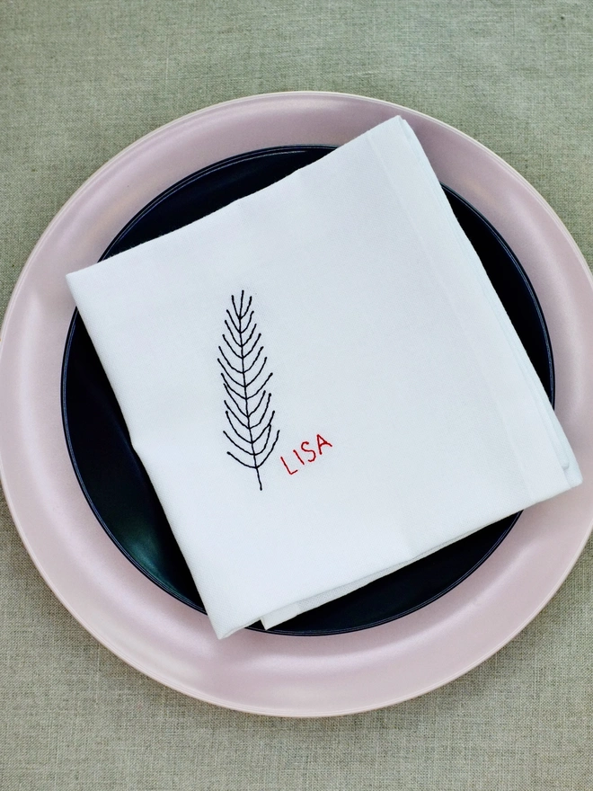 Fir embroidered napkin with custom name in red block text, cotton Christmas napkin