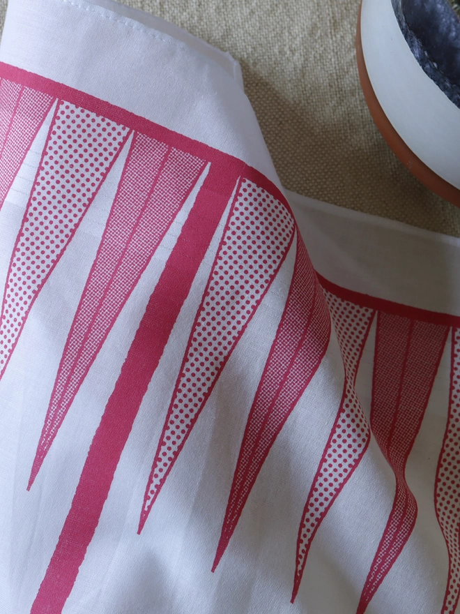 detail of a Mr.PS Backgammon Hankie printed in raspberry with the edge of a plant pot.