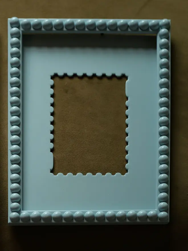 powder blue coloured stamp shaped frame mount