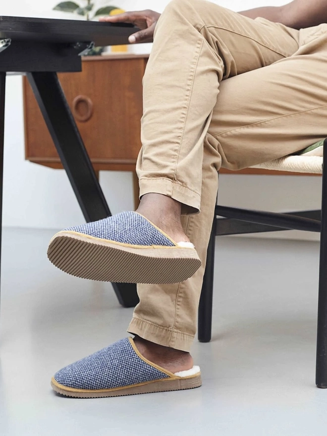 Lambswool & Sheepskin Slippers, a person wearing a pair of colourful lambswool and sheepskin slippers. 