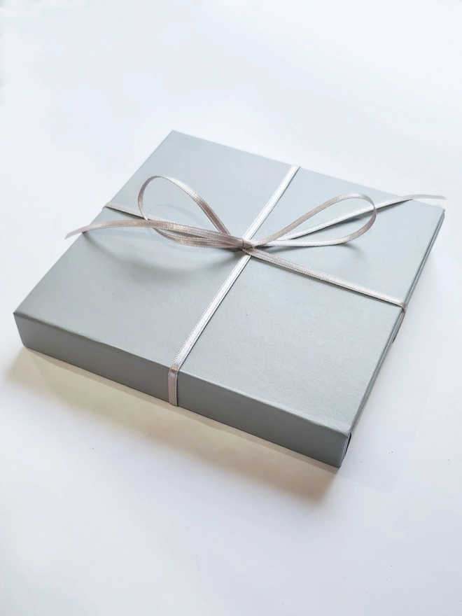 natthakur grey gift box with silver ribbon