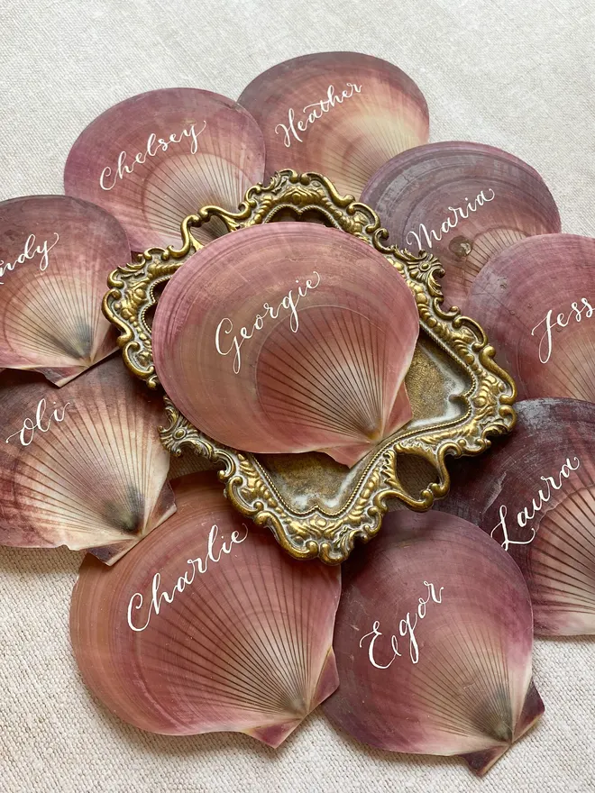 Scallop shell wedding place names with white ink calligraphy