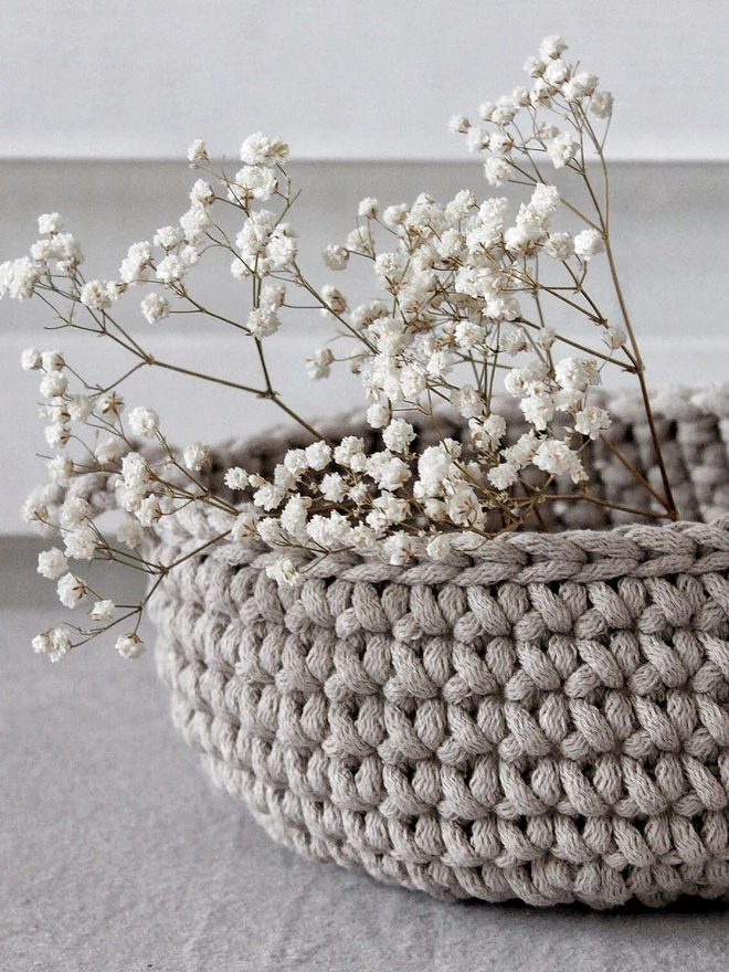 crochet basket with handles in a beige colour
