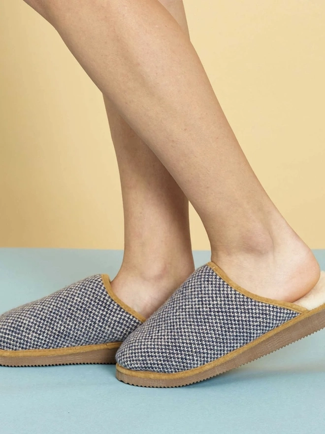 Lambswool & Sheepskin Slippers, a person wearing a pair of colourful lambswool and sheepskin slippers. 