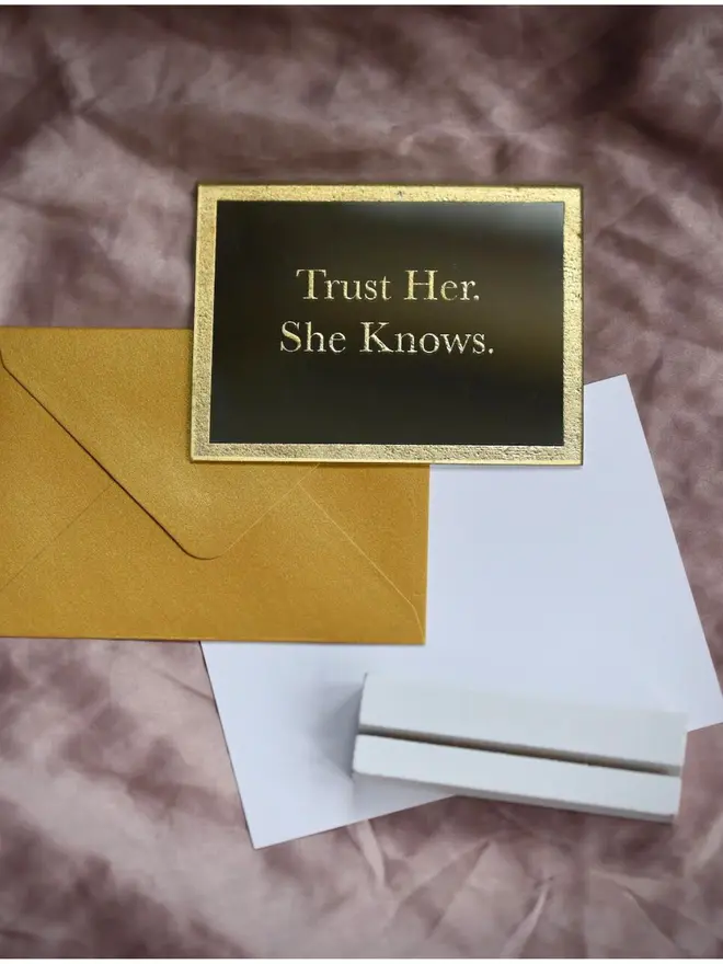 'Trust Her. She Knows' gold etched mirror on pink silk with gold envelope, wooden stand and note