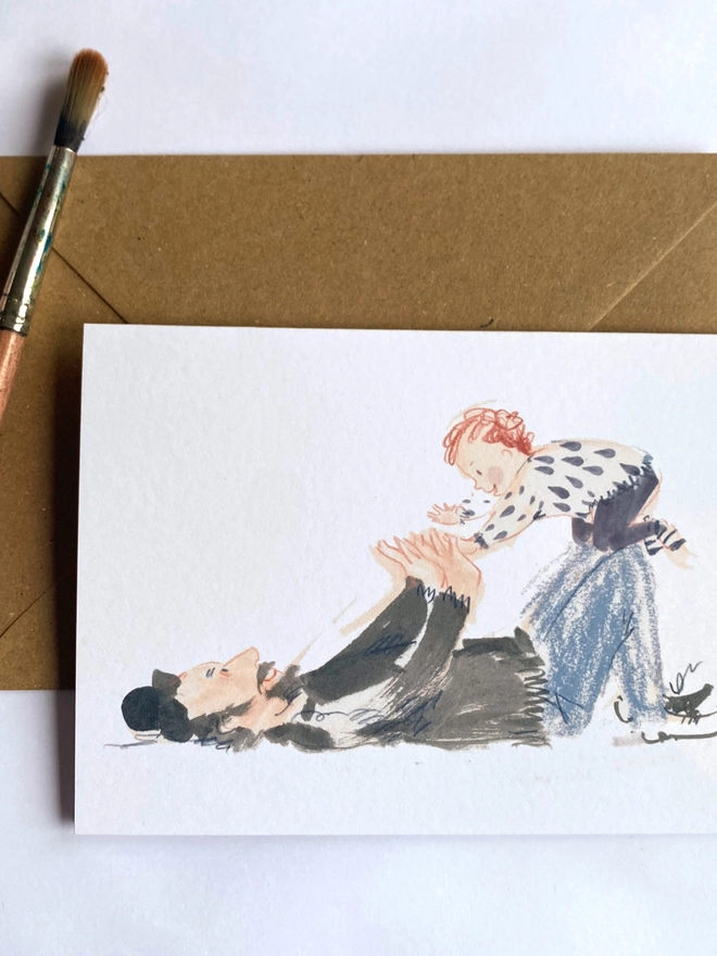 Esther Kent illustrated greetings cards showing a dad playing on the floor with child balancing on knees