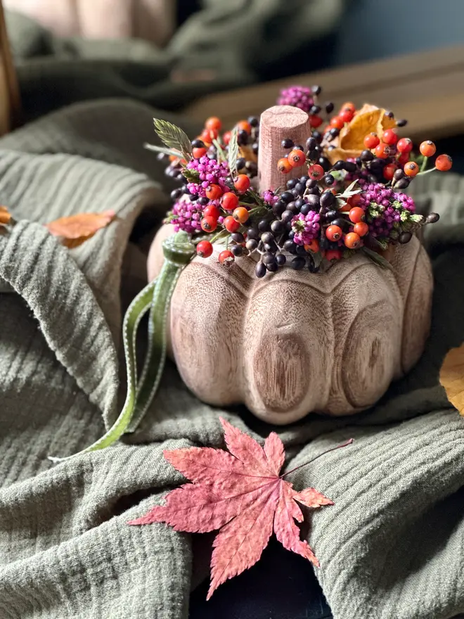 A Carved Mango Wood Pumpkin with Heather and Berry Crown