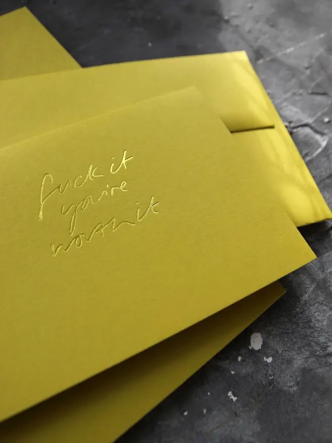 Hand foiled cash card or money wallet in a chartreuse green colour handfoiled in shiny yellow foil text which says ‘Fuck it you’re worth it’.