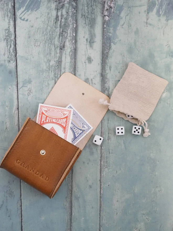 Personalised Leather Playing card and dice carry case. A hand dyed tan brown leather pouch holding two decks of cards and 6 dice. Personalised with the name GRANDAD.