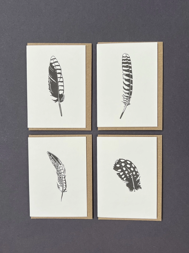 An image of the four feather designs on letterpress printed small card