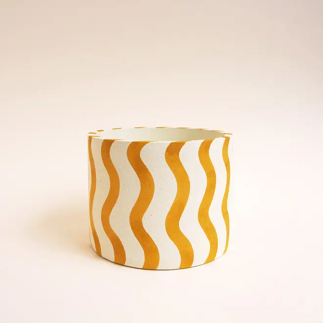 Large Stripes Jesmonite Pot. White ceramic pot decorated with vertical yellow wavy stripes against a plain light background.