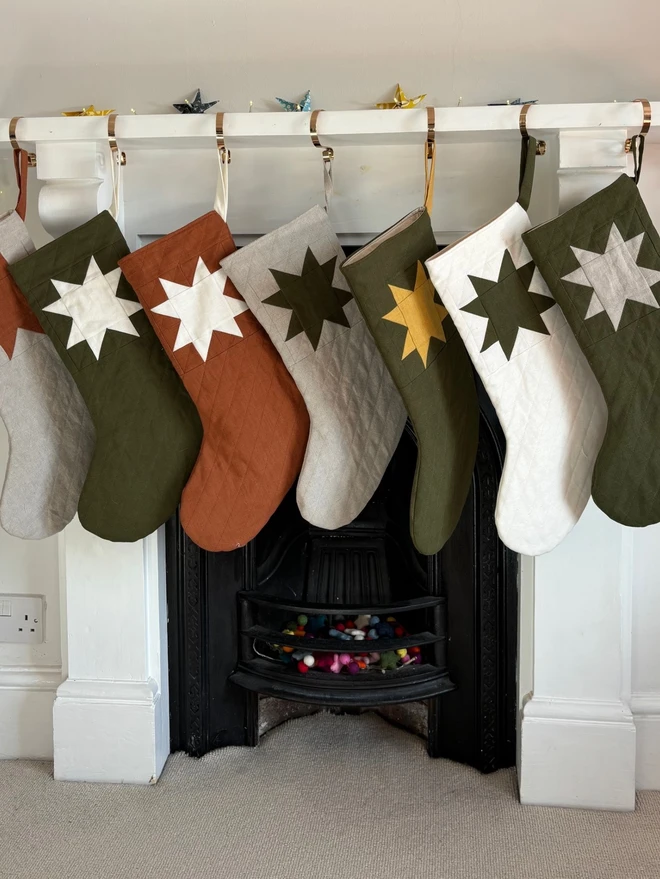 Medium Star Quilted Linen Christmas Stockings. A variety of colours of stocking and star.